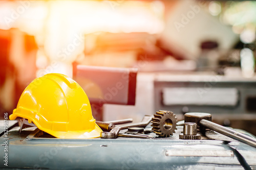 Fotografía yellow helmet hardhat with instruments gear tools in factory for background