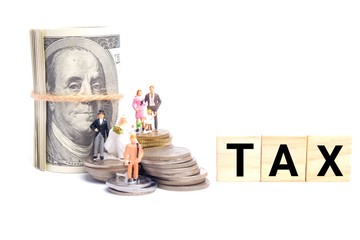 Taxation concept with miniatures, stack of coins and fake cash. Taxation for certain countries will revise cause by covid 19 and economic turmoil.