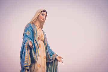 Wall Mural - The blessed Virgin Mary statue figure in a sunset time. Catholic praying for our lady - The Virgin Mary.