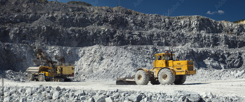 Mining excavator, heavy mining dump truck and tractor with a scraper in ...