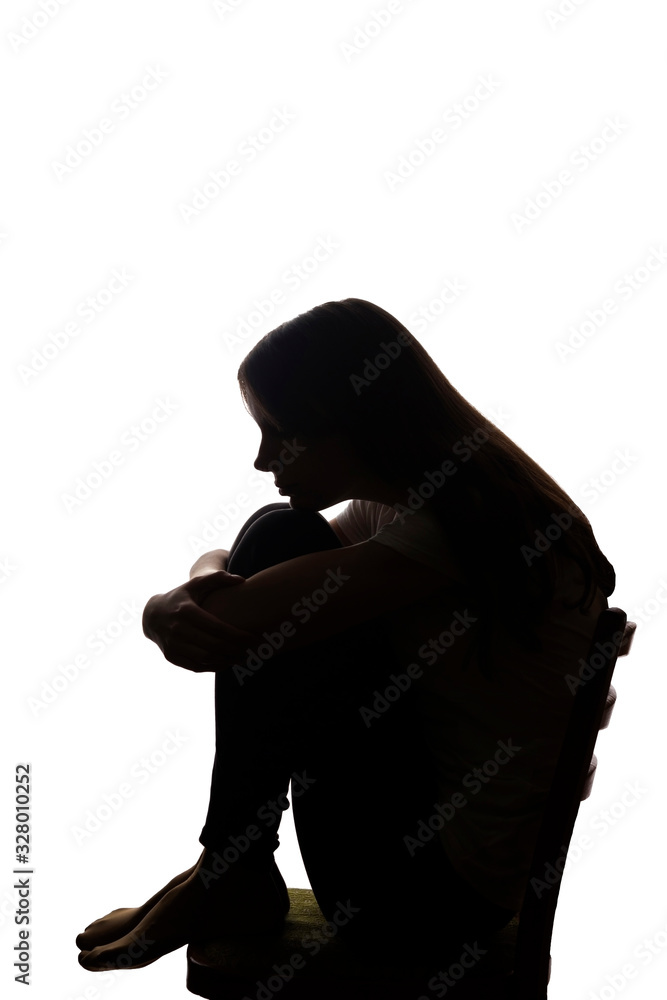 Young beautiful girl in grief hugged her knees - silhouette Stock Photo ...