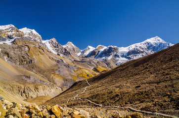 Trekking route to Thorung La pass in sunny day with Mt. Chulu on the horizon. Annapurna circuit trek, Nepal.