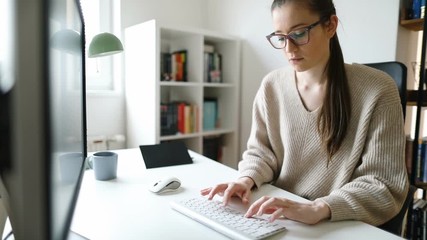 Wall Mural - Young businesswoman working on computer at her home office