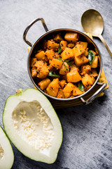 Wall Mural - Kaccha Papita Sabji or Raw Papaya Sabzi, served in a karahi or bowl. selective focus