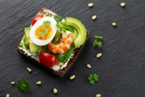 Fototapeta Mapy - Toast with egg, shrimp, avocado, cheese, parsley and pine nuts