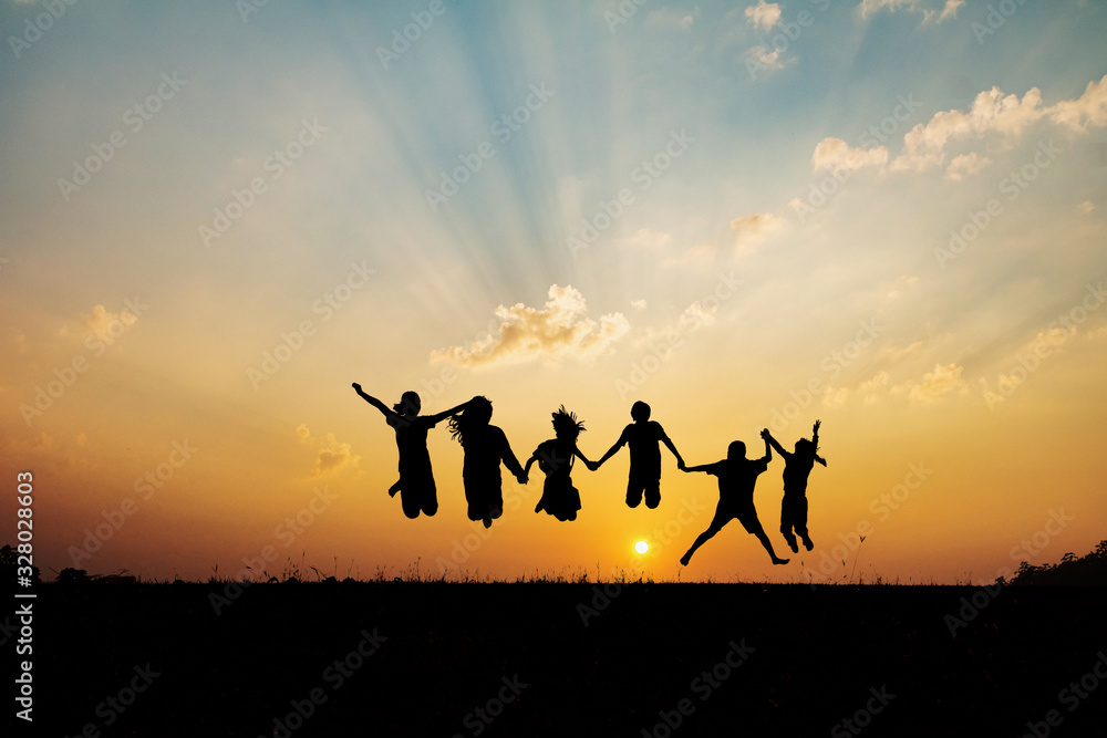 Silhouette group of happy children jumping playing on mountain at ...