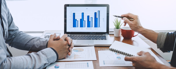 Fototapete - Business casual manager presenting and discussing company growth project success financial statistics, professional investor working start up project for strategy plan with document