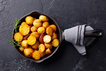 Roasted Baby Potatoes In Iron Skillet. Dark Grey Background. Top View.