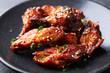 Chicken wings. Traditional asian recipe. Dark background. Close up.
