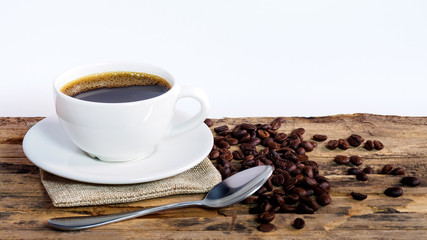 Wall Mural - Coffee cups and coffee beans roasted on a wooden table