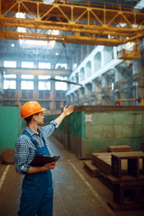 Wall Mural - Master looks at work of crane operator on factory