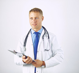 Wall Mural - Young confident doctor in a white coat with a stethoscope