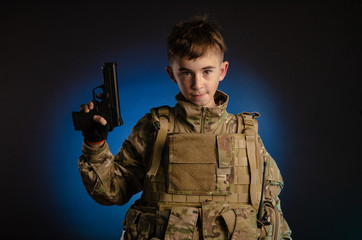 a boy in military uniform with a gun