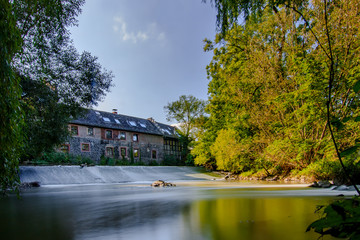 Wall Mural - autumn in the park,long exposure on a river, with natural border and old buildings