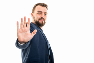 Business man wearing smart casual clothes showing stop gesture