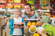 © JackF - mother with little boy buying fruits and vegetables at store