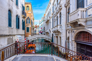 Wall Mural - narrow canal with bridge in venice, italy. architecture and landmark of venice. cozy cityscape of ve