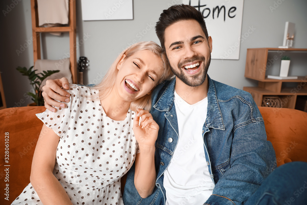 Young couple video chatting at home