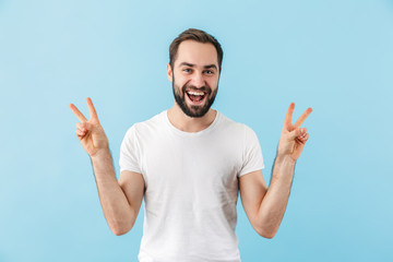 Wall Mural - Portrait of a young cheerful bearded man wearing t-shirt