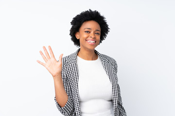 Wall Mural - African american woman with blazer over isolated white background saluting with hand with happy expression