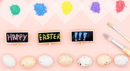 Wall Mural - Happy easter card. Little quail eggs are ready to paint lying on the bottom of image. There are two tassels. Five different colours are on the top. exclamation mark. Pink background. 