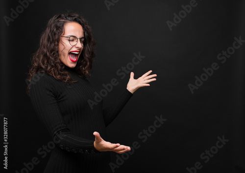 Cuadros en Lienzo young pretty woman performing opera or singing at a concert or show, feeling romantic, artistic and passionate against black background