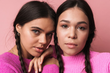 Wall Mural - Image of two attractive teenage girls with braids looking at camera