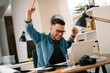© JustLife - Handsome businessman celebrating won. Portrait of businessman in office.