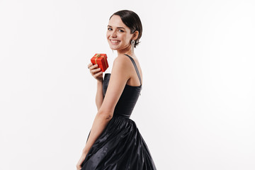 Wall Mural - Attractive young brunette woman wearing black cocktail dress