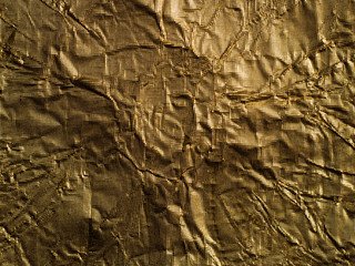 Golden wrinkled foil pattern background.