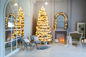 Wall Mural - Festive room interior with stylish furniture and beautiful Christmas tree, blurred view