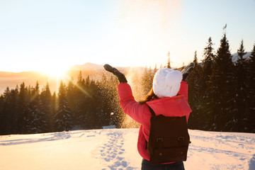 Sticker - Young woman having fun outdoors on snowy winter day. Space for text