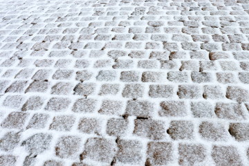 Cobblestone paving road under the snow