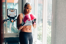 Young Woman Wearing Boxing Gloves