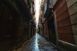 © PhotoAlto - View of narrow wet alleyway in Gothic quarter, Barcelona, Spain