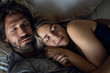 © PhotoAlto - Close-up of young couple sleeping on bed in bedroom