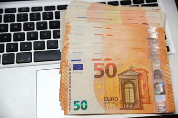 euro money and computer keyboard - economic transaction and bank on line shopping