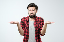 Confused Hispanic Man Giving I Dont Know Gesture On White Background.
