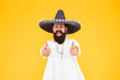 Fest and holiday. Celebrate traditions. hipster looks festive in sombrero. celebrating fiesta. happy man wear poncho. having fun on mexican party. sombrero party man. man in mexican sombrero hat