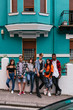 © Kike Arnaiz/Stocksy - Group of attractive young friends standing and looking at the ca