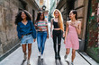 © Kike Arnaiz/Stocksy - Group of women walking down the street having fun together