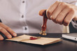 © burdun - Male attorney stamping document. Seal on notarized paperwork