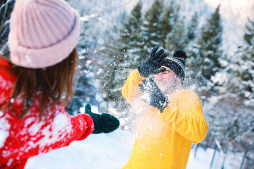 Sticker - Happy couple playing snowballs outdoors. Winter vacation