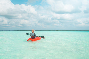 Canvas Print - Man navigating in kayak the Bacalar Lagoon, near Cancun in Riviera Maya, Mexico