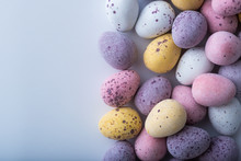 Colorful Mini Easter Eggs On A Plain Back Ground With Copy Space