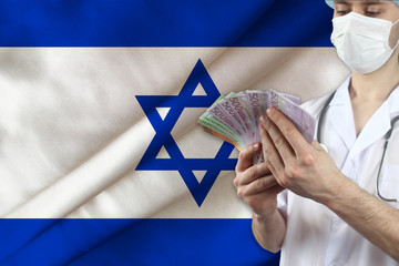 doctor with a stethoscope holds euro banknotes on the background of the israel silk national flag, the concept of medical insurance, budget, cost of treatment, organ donation