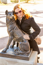 Young Woman  Embraces Statue Of Dog