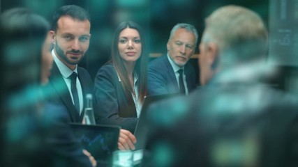 Wall Mural - The people sitting at the table and talk at the business meeting