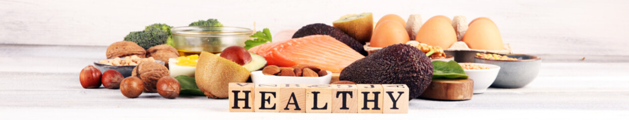 Wall Mural - healthy eating and diet concept, natural rich in protein food on rustic table with wooden letter protein