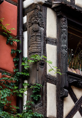 Wall Mural - Classic Alsatian windows in a half-timbered house, decorated with wooden carvings and flowers